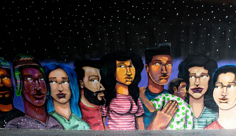A photo of a wall mural of 7 cartoon people with varying skin colors.